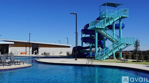 A blue water slide in a pool.