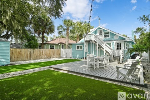 A house with a blue exterior and a wooden deck.