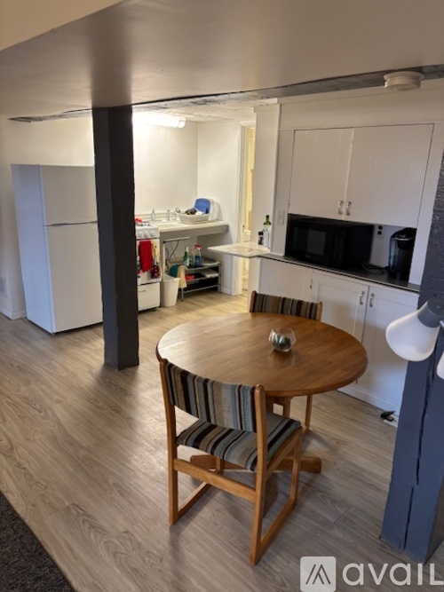 A kitchen with a table and chairs in the middle of the room.