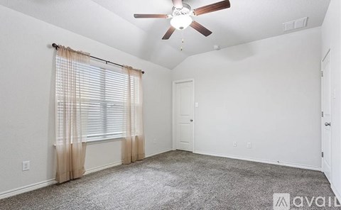 A room with a ceiling fan and carpeted floor.
