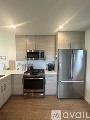 A kitchen with a stainless steel refrigerator and oven.