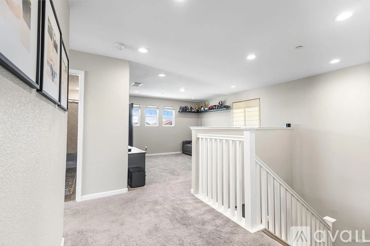 A spacious room with a staircase and a window.