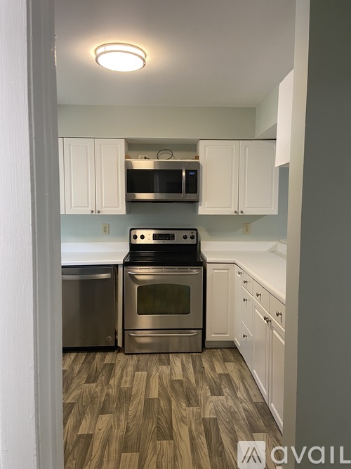 A kitchen with a stove top oven and microwave.