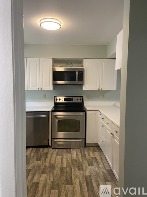 A kitchen with a stove top oven and microwave.