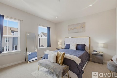 A bedroom with a large bed and a chair.