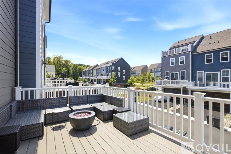 A deck with a hot tub and seating area.