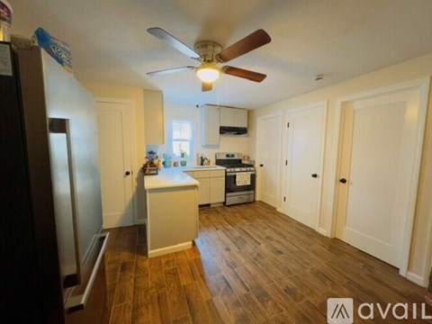 A kitchen with a refrigerator, sink, and stove.