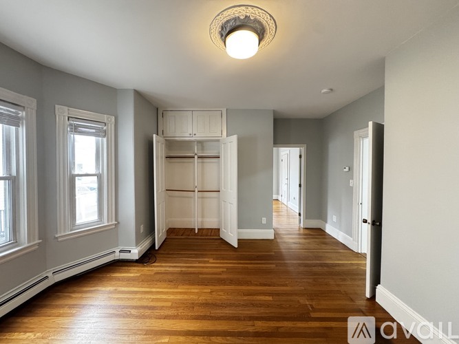 A room with wooden floors and a large open space.