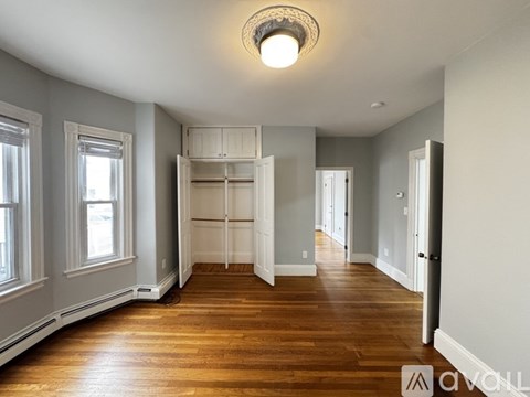 A room with wooden floors and a large open space.