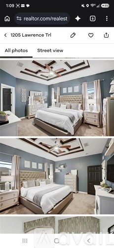 A bedroom with a large bed and a ceiling fan.
