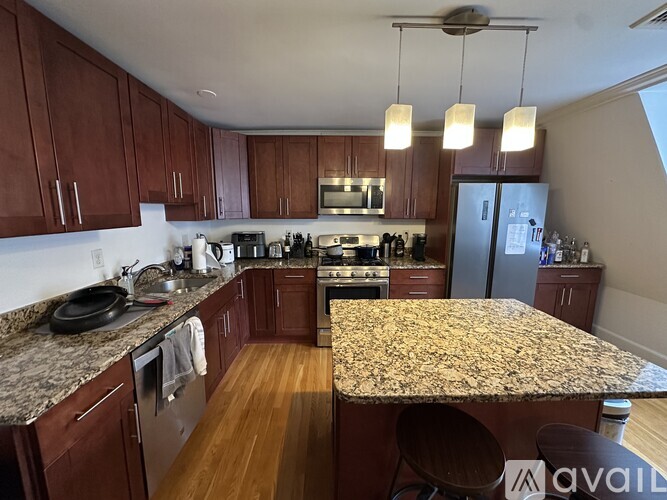 A kitchen with wooden cabinets and granite countertops.
