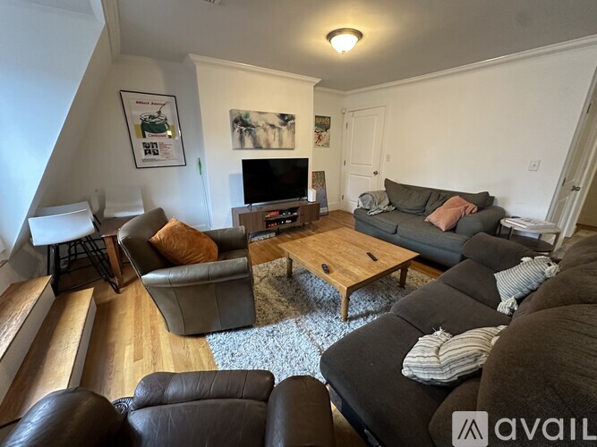 A living room with a grey couch and a wooden coffee table.