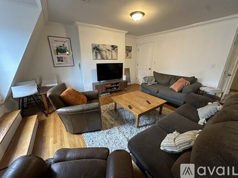 A living room with a grey couch and a wooden coffee table.