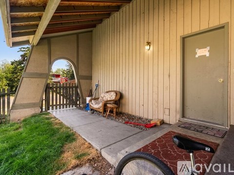 A wooden building with a door and a bicycle in front.