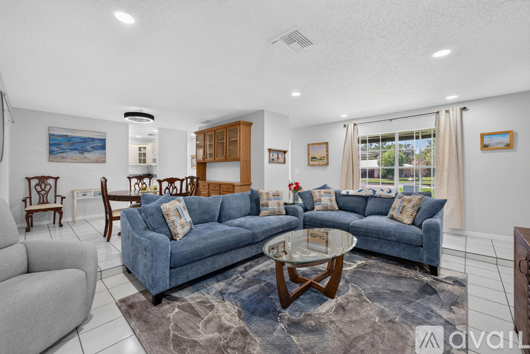 A living room with a blue couch and a coffee table.