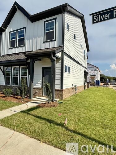 A two-story house with a white and black exterior is located at Silver F.