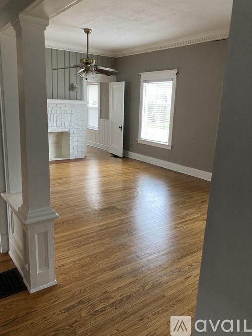 A room with wooden floors and a fireplace.