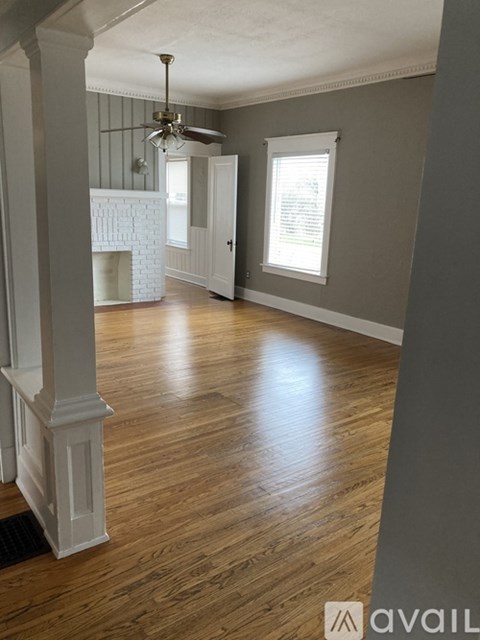 A room with wooden floors and a fireplace.