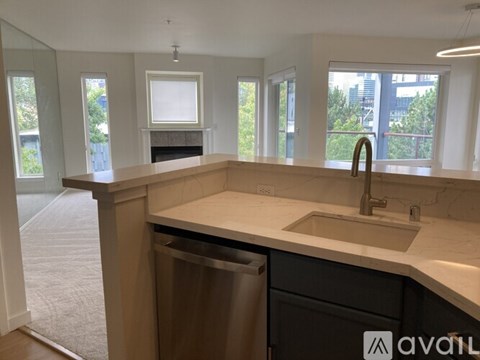A kitchen with a sink and a window.