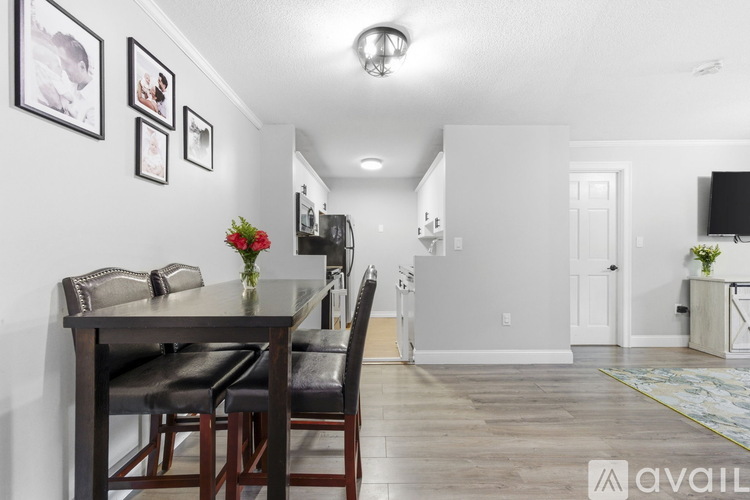 A dining room with a table set for four.