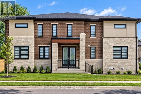 A modern brick house with a black gate in front.