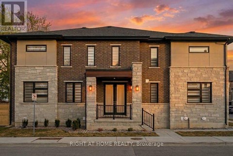 A modern two-story house with a front porch and a garage door.