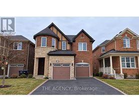 A large brick house with a sign that says "The Agency Brokerage".