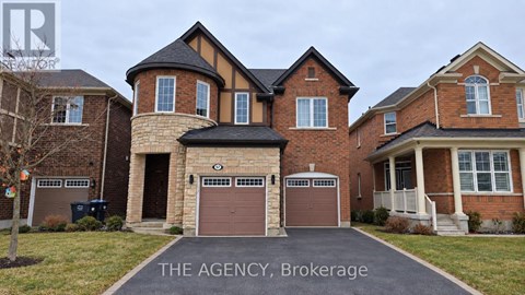 A large brick house with a sign that says "The Agency Brokerage".