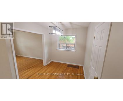 A room with a window and a door is for sale.