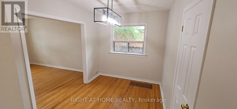A room with a window and a door is for sale.