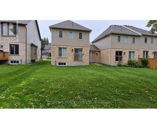 A real estate company is advertising a property with a large grassy area in front of a two-story house.