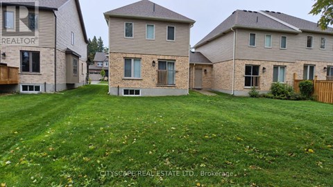 A real estate company is advertising a property with a large grassy area in front of a two-story house.