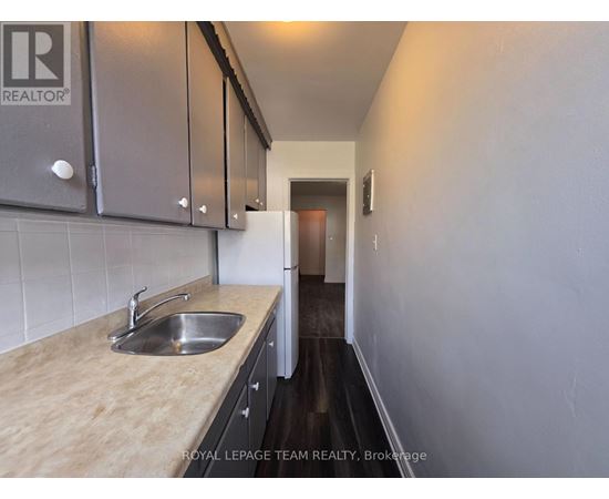 A kitchen with a sink and cabinets.