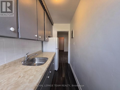 A kitchen with a sink and cabinets.