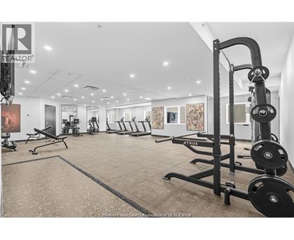 A gym with a variety of equipment including weights and benches.