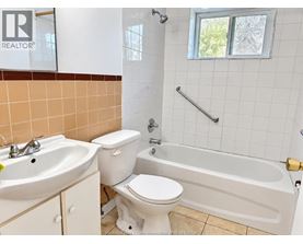 A bathroom with a toilet, sink, and bathtub.