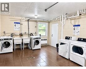 A laundry room with washers and dryers.
