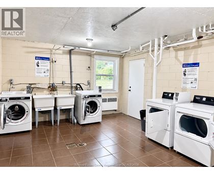 A laundry room with washers and dryers.