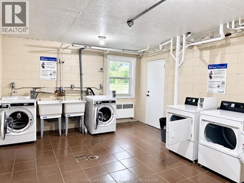 A laundry room with washers and dryers.