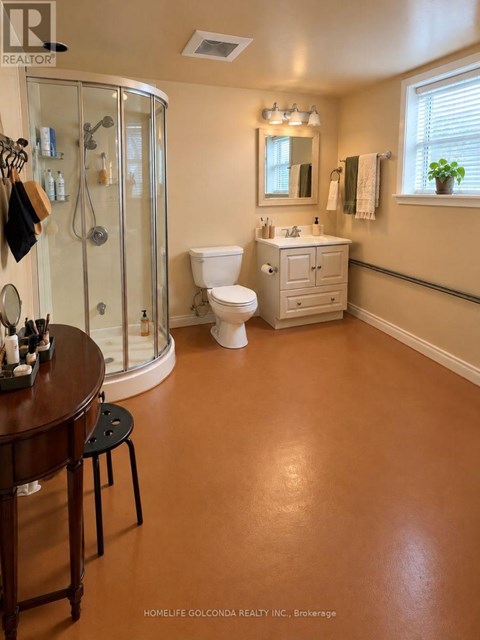 A bathroom with a toilet, sink, and shower.
