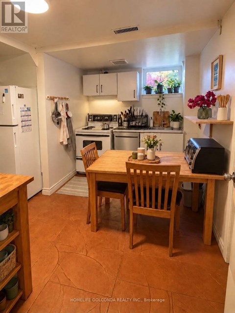 A kitchen with a table and chairs in the middle of the room.