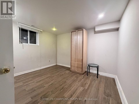 A room with a wooden floor and a small table.