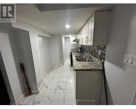 A kitchen with a sink and a counter.