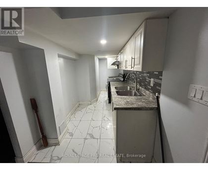 A kitchen with a sink and a counter.