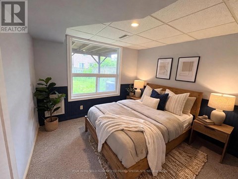 A bedroom with a large bed and a window.