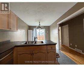 A kitchen with wooden cabinets and a black countertop.