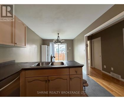 A kitchen with wooden cabinets and a black countertop.