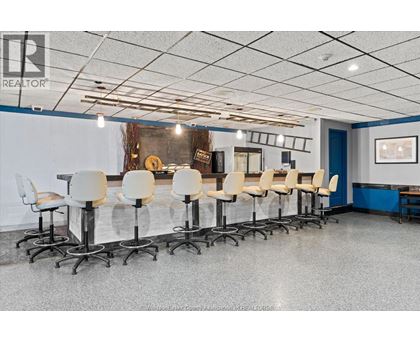 A conference room with white chairs and a grey floor.