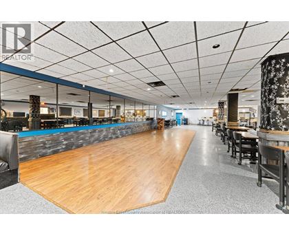 A spacious room with a long wooden table in the center.