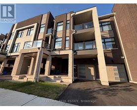 A modern apartment building with balconies and garage doors.